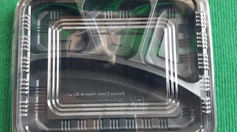 Prepared takeaway meal in a food container for meal delivery versus home cooking comparison