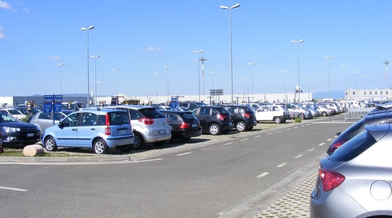 Rental cars parked at an airport for an article about rental car insurance coverage